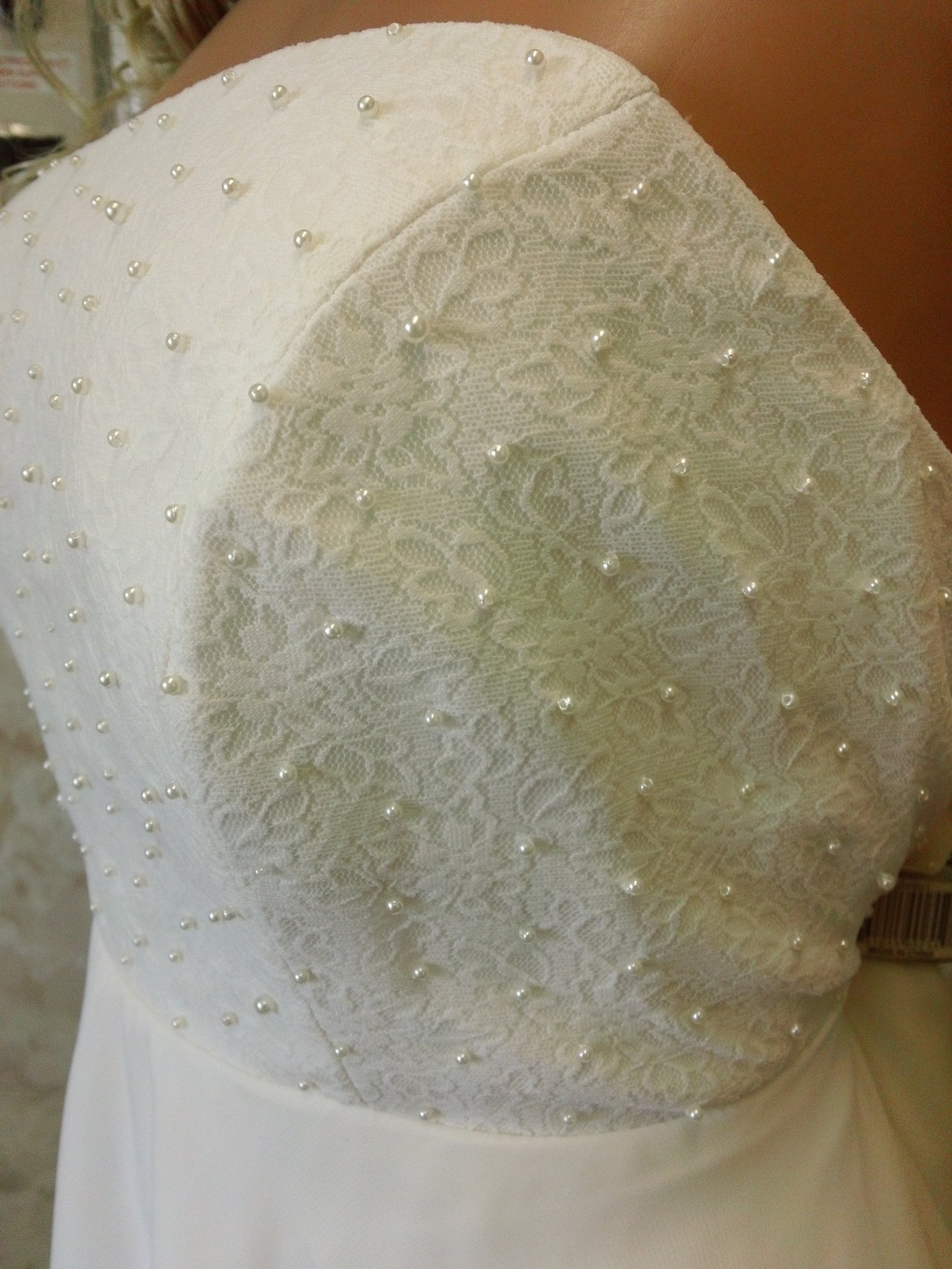 lace bodice is accented with faux pearls